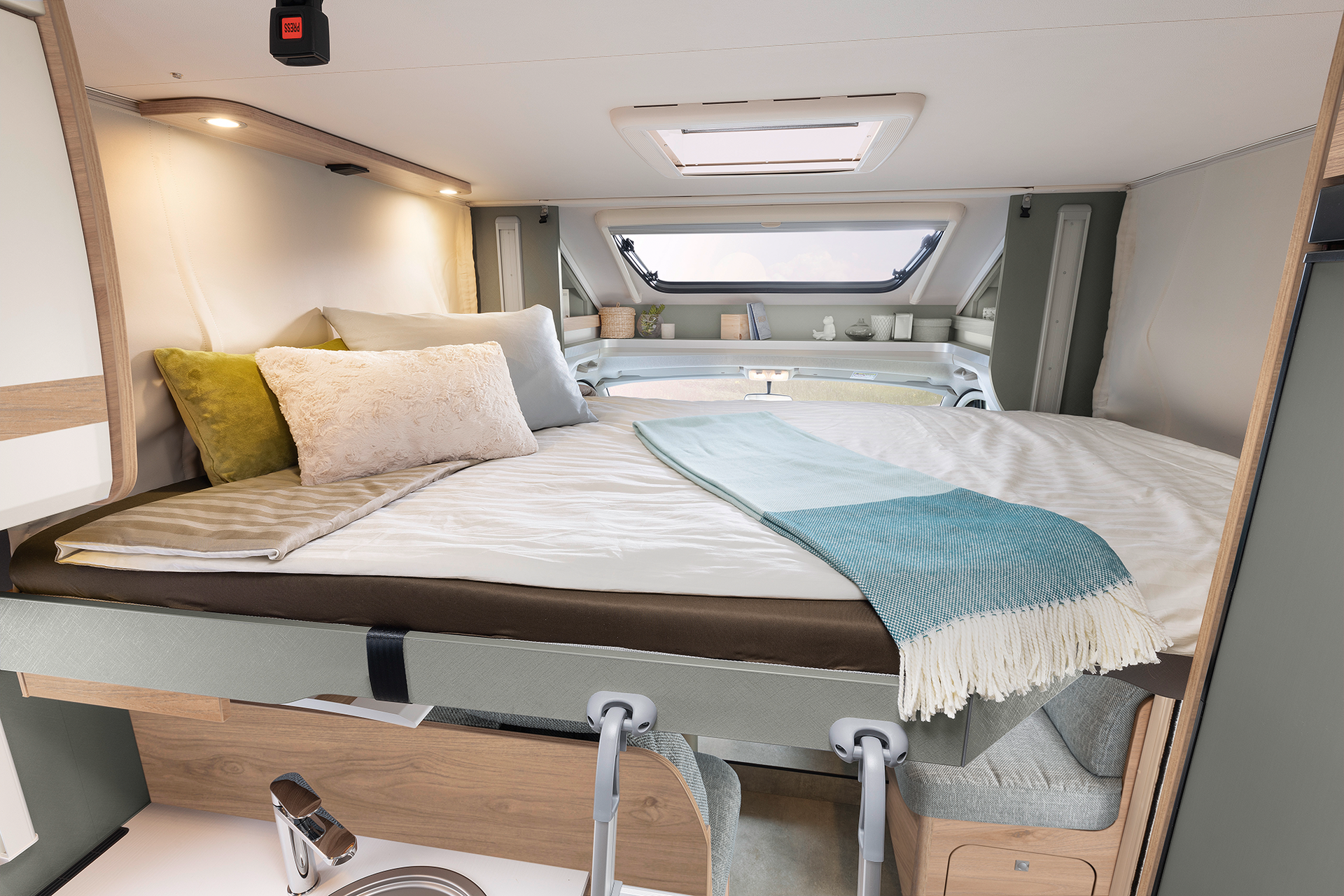 Electrically operated two-person pull-down bed above the seating lounge (option)