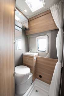 Fixed bathroom: functional bathroom with large shower, storage options and mirror surfaces.