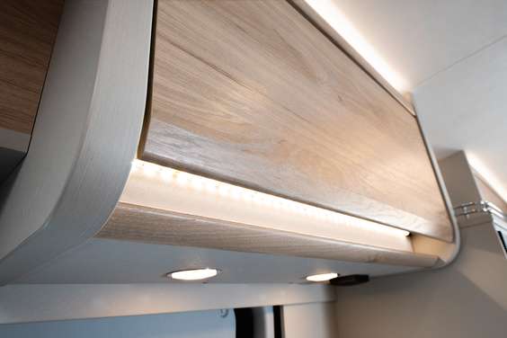 Ambient lighting on the overhead lockers and kitchen drawers creates a cosy ambience.