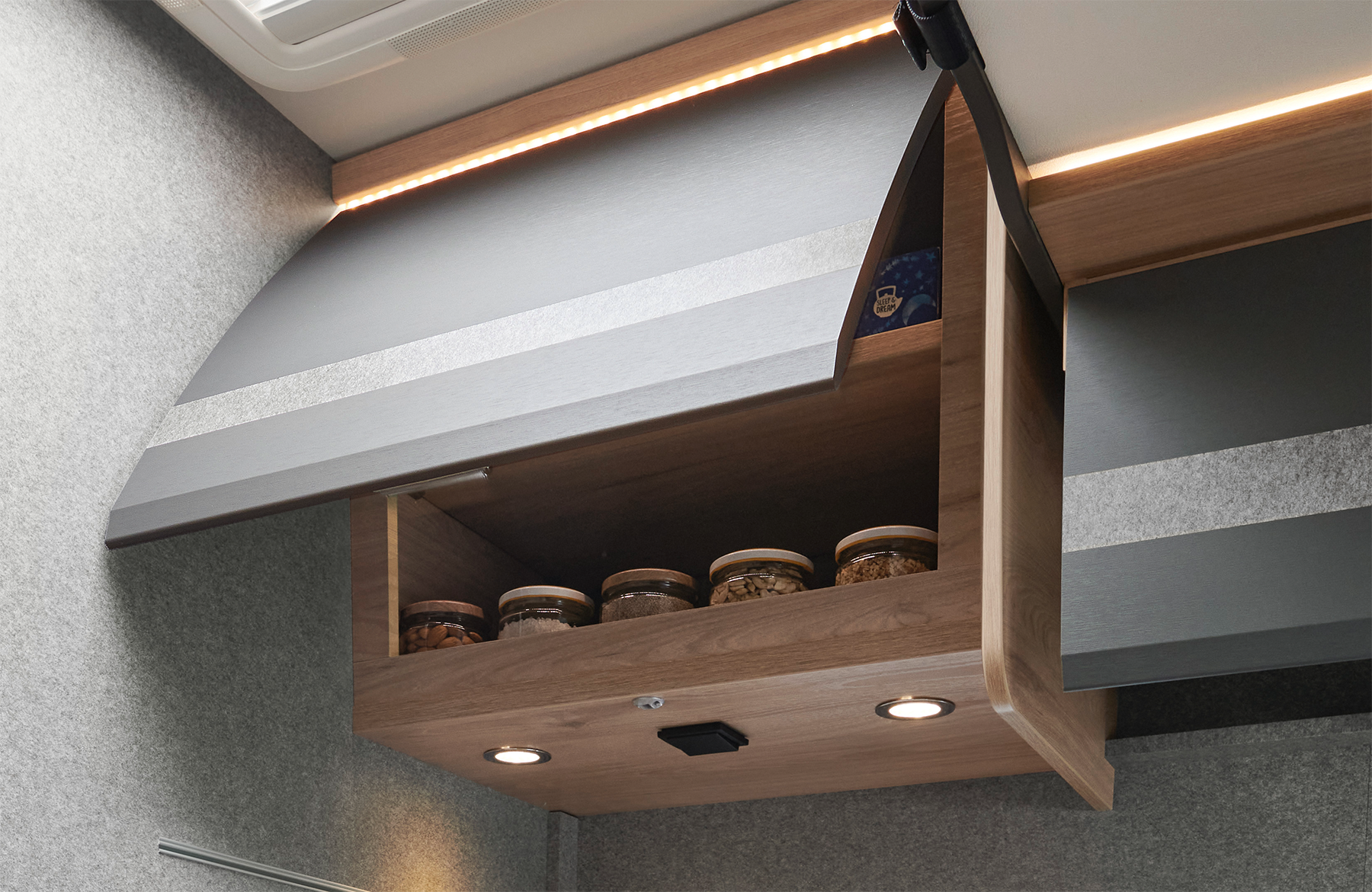 The overhead lockers are equipped with a soft- close function and are indirectly illuminated.